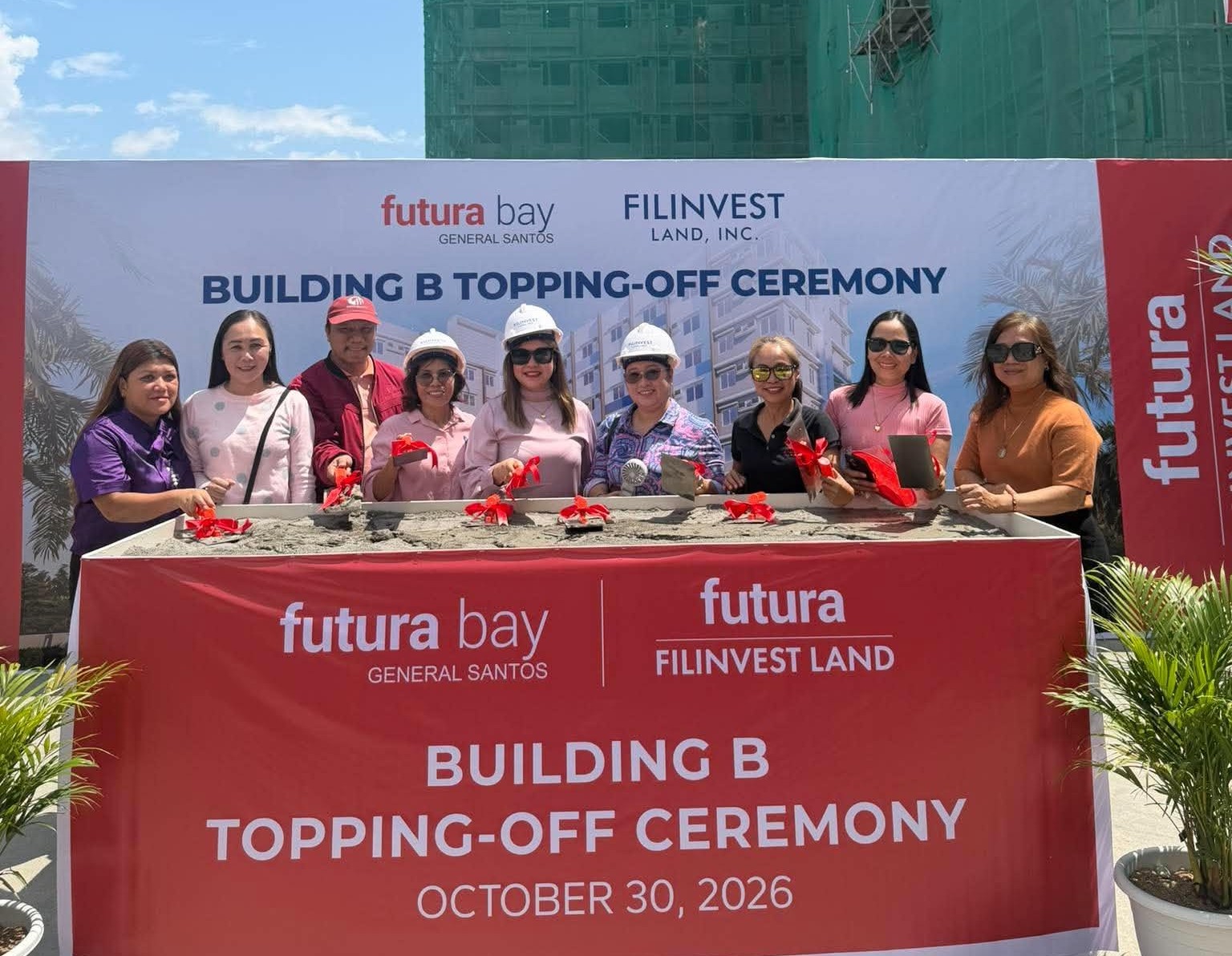 Group of attendees at the Futura Bay General Santos Building B topping-off ceremony on October 30, 2026, with the condominium construction site in the background.